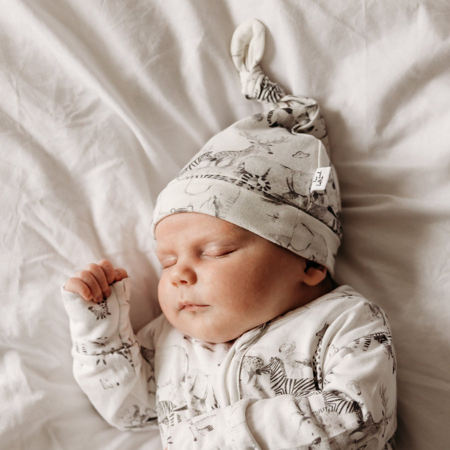 Baby in animal hat and animal sleepsuit. Fox anf Lottie premium baby and infant sleepwear.