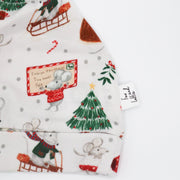 Christmas baby print hat from Fox and Lottie. Close up showing mouse with Christmas card and Christmas tree.