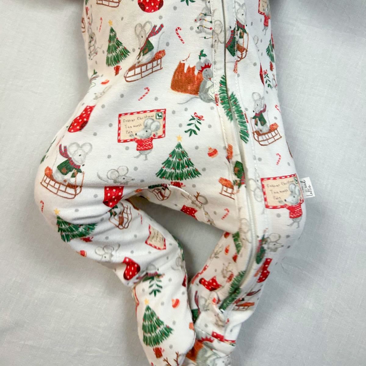 Baby sleepsuit from Fox and Lottie, Christmas print close up.