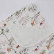 Baby blanket with farm animal pattern on a white background
