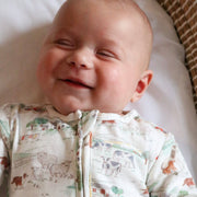 Baby laughing in farm sleepsuit