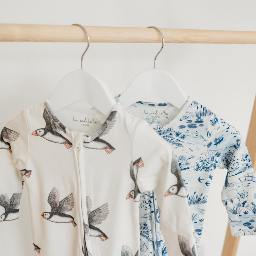 Puffin and on the river sleepsuit on rail. Fox and Lottie premium children sleepwear. Baby blankets, sleepsuits, pyjamas, baby hats and muslins.