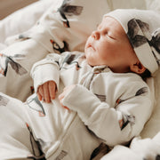 Baby in puffin sleepsuit with puffin hat and puffin blanket